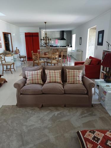 a living room with a couch and a dining room at Country house Quinta da Salgueira in Alijó
