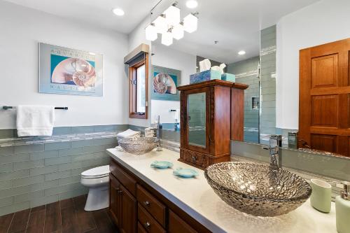 a bathroom with two sinks and a toilet at H248 - Hamilton Cove Villa 2-48 in Avalon