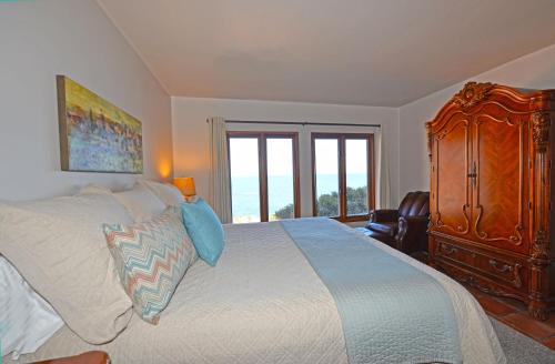 a bedroom with a bed with a dresser and a window at H319 - Hamilton Cove Villa 3-19 in Avalon