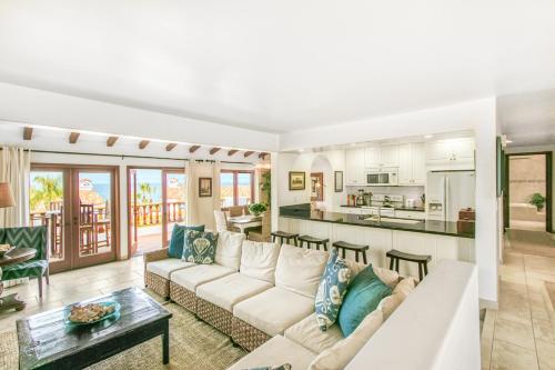 a living room with a white couch and a kitchen at H412 - Hamilton Cove Villa 4-12 in Avalon