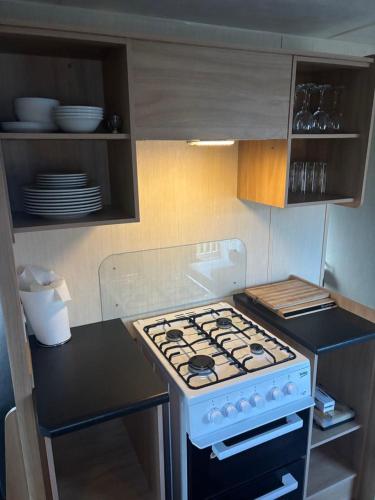 a kitchen with a stove top oven in a kitchen at 15 Maple Rise in Gristhorpe