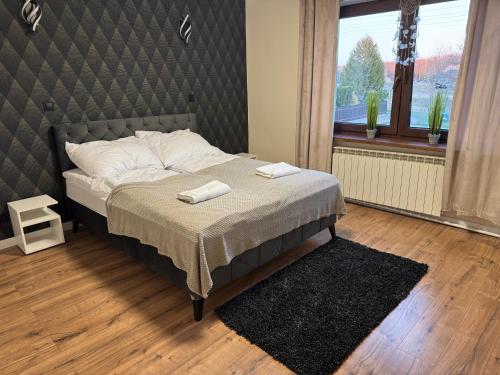 a bedroom with a bed with two towels on it at Oaza Spokoju in Augustów