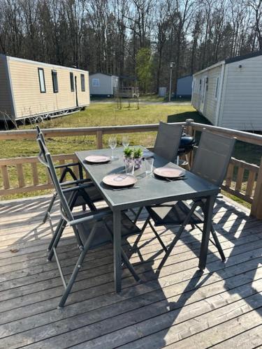 a table and two chairs sitting on a deck at Figaro - Gasselte, Drenthe, 4 persoons, airco in Gasselte