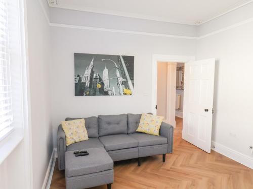 a living room with a couch and a picture on the wall at Harpham Manor House in Lowthorpe