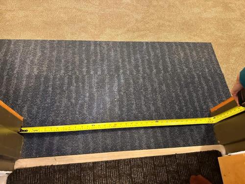 a yellow measuring tape on top of a black mat at W118 NEW! Central Canmore- Light Industrial Hotel Room in Canmore