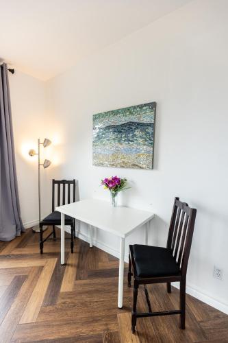 a white dining room table with a vase of flowers on it at Vineyard estate with pool and amazing views in Yucaipa
