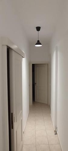 an empty room with a hallway with a ceiling at Sea-Cret Beachfront Apartment in Makry Gialos