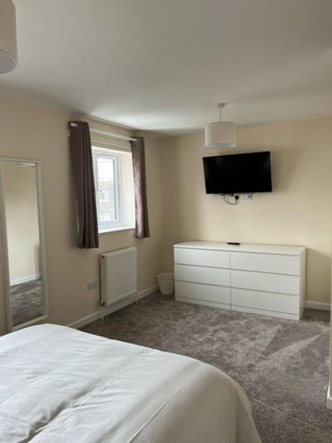 a bedroom with a bed and a flat screen tv at Flat At 34 in Street