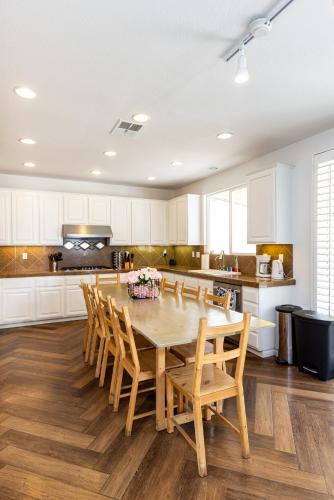 a kitchen with a wooden table and chairs at Vineyard estate with pool and amazing views in Yucaipa