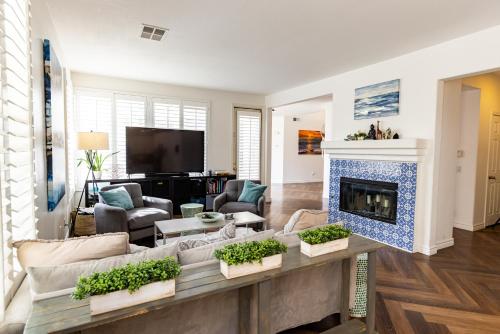 a living room with a couch and a fireplace at Vineyard estate with pool and amazing views in Yucaipa