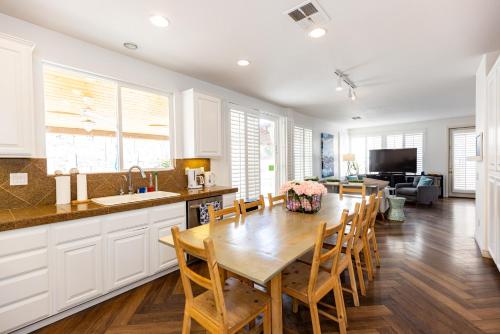 a kitchen with a wooden table and chairs in a room at Vineyard estate with pool and amazing views in Yucaipa
