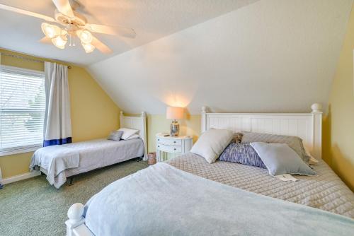 a bedroom with two beds and a ceiling fan at Lake Cumberland Home with Hot Tub and Game Room in Burnside