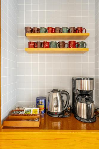 a kitchen counter with a coffee maker and a blender at Togari Inn Suites in Iiyama