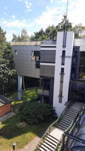 a building with stairs in front of a building at Apartament w Sosnowym SPA in Serock