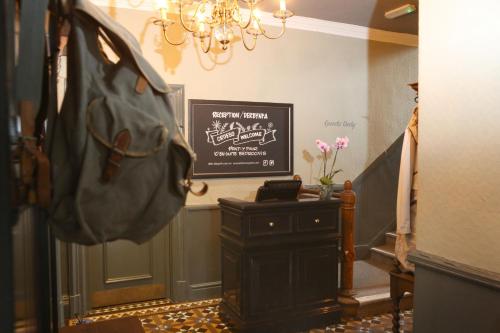 a hallway with a table and a sign on the wall at Pont y Pair Inn in Betws-y-coed