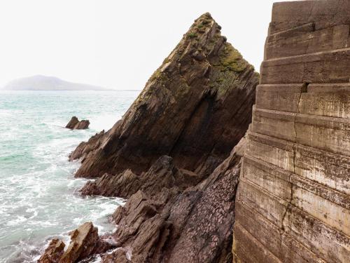 a large rock formation next to the ocean at Barr na hAille in Dunquin