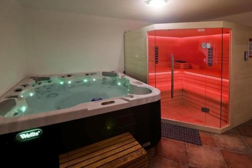 a large bathroom with a tub and a red shower at House Grga in Gornja Voća