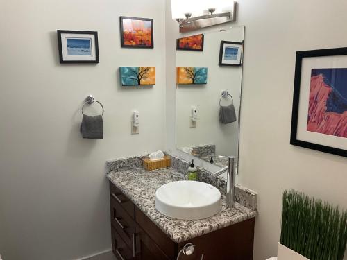 a bathroom with a sink and a mirror at Lily glacier suite at silver bear condos in Revelstoke