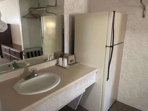 a bathroom with a sink and a refrigerator at Aurora Inn in Aurora
