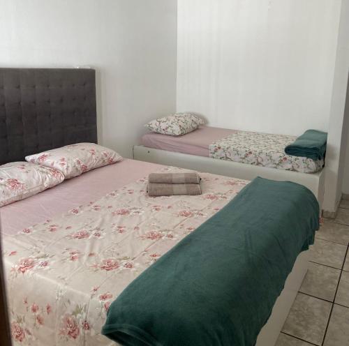 Una cama o camas en una habitación de Casa Dê - Hostel