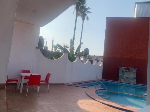 a room with a swimming pool and a table and chairs at Hotel Boutique TEKALI INN in Cuetzalán del Progreso
