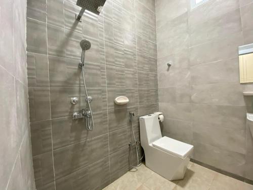 a bathroom with a shower with a toilet in it at Sea Turtles Guest House #2 Ras Al Hadd in Al Ḩadd