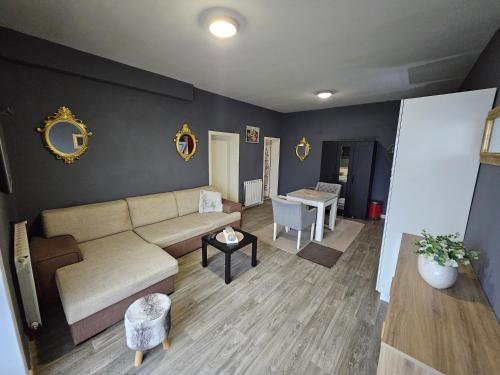 a living room with a couch and a table at Apartman Green Hill in Zagreb