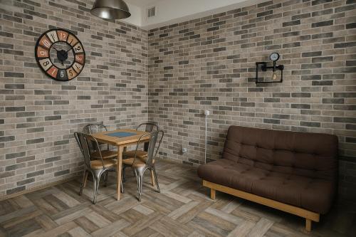 a room with a table and a couch and a clock at Mondello's Pearl in Mondello