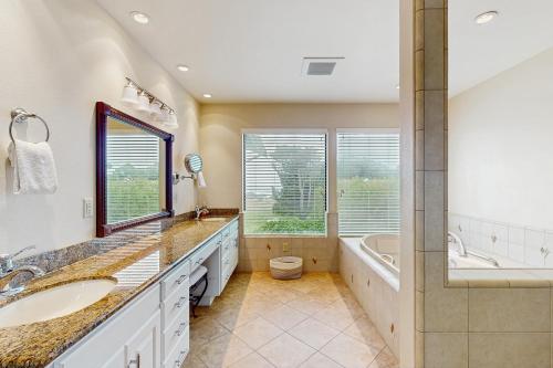 a bathroom with two sinks and a tub and a toilet at Sunset Point in Fort Bragg
