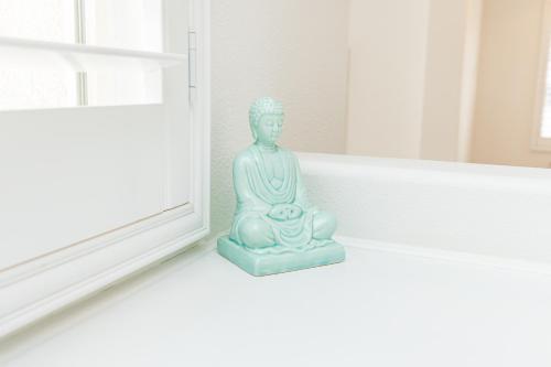 a statue sitting on the floor next to a window at Vineyard estate with pool and amazing views in Yucaipa