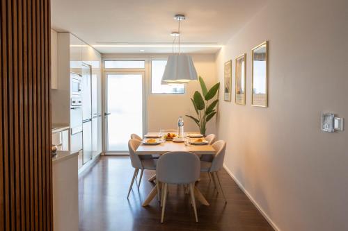 a dining room with a table and chairs at Terraço da Vila in Lousada