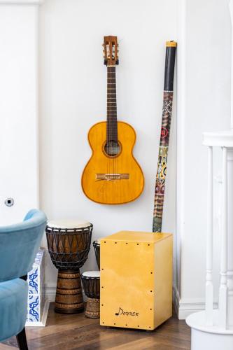 a guitar and a box in a room with two guitars at Vineyard estate with pool and amazing views in Yucaipa