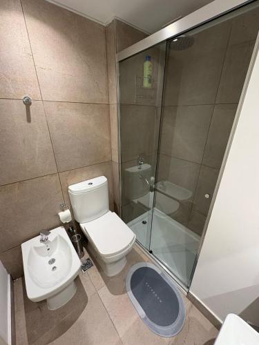 a bathroom with a toilet and a shower and a sink at HUB Apart Nuñez in Buenos Aires