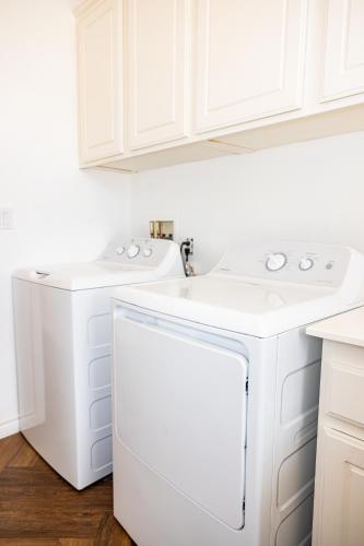 a kitchen with white cabinets and a dishwasher at Vineyard estate with pool and amazing views in Yucaipa