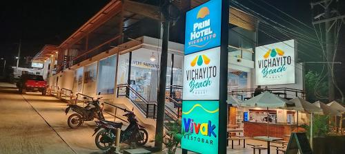 a sign in front of a restaurant at night at Prim Hotel Vichayito in Vichayito