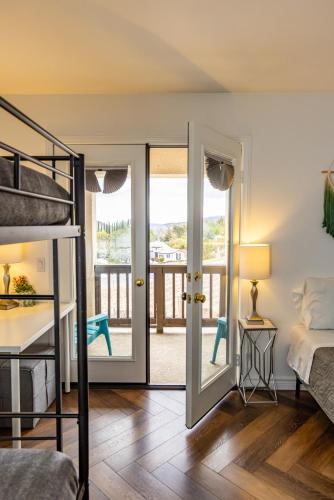 a bedroom with a bunk bed and a balcony at Vineyard estate with pool and amazing views in Yucaipa