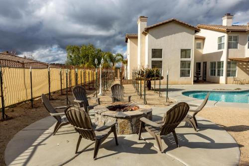 a group of chairs around a fire pit in a yard at Vineyard estate with pool and amazing views in Yucaipa