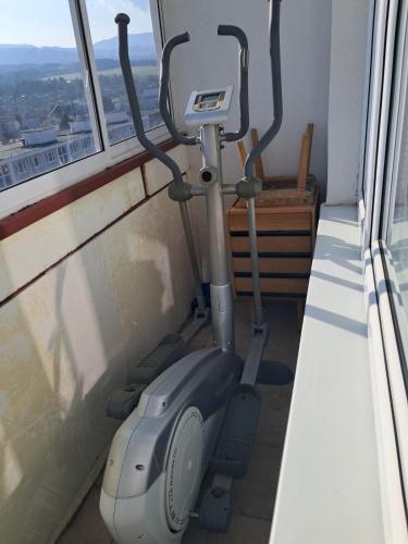 an exercise bike in a room with a window at Spacious flat in Prievidza near Bojnice with a beautiful view in Prievidza