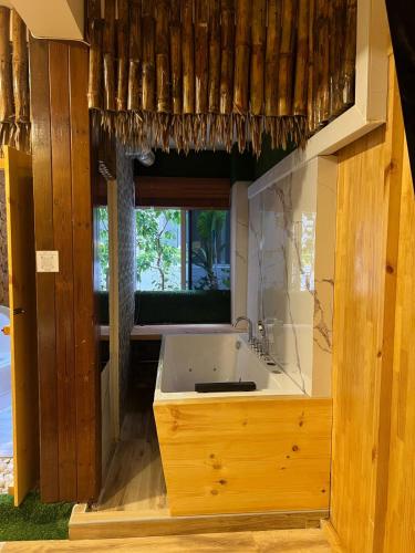 a bathroom with a sink and a window at Rooftop inn in Filitheyo