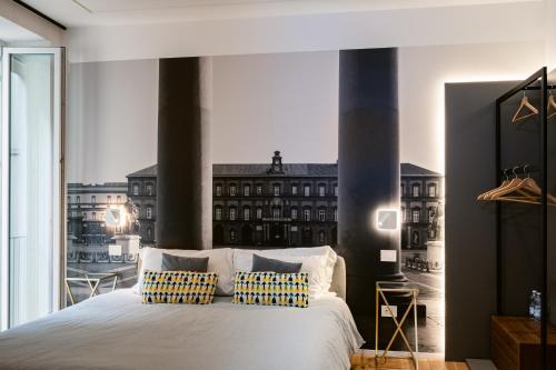 a bedroom with a white bed with a large window at NILO RELAIS a san domenico maggiore in Naples