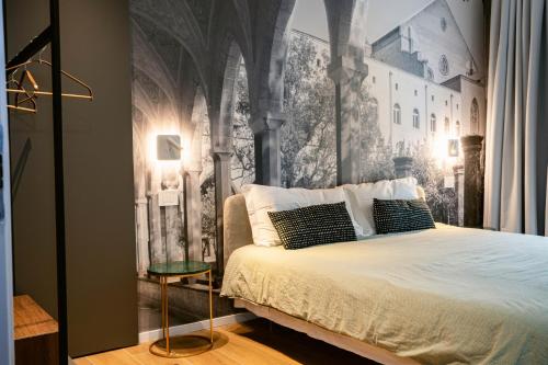 a bedroom with a bed with a wall mural at NILO RELAIS a san domenico maggiore in Naples