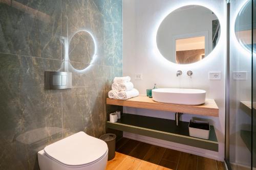 a bathroom with a sink and a mirror at NILO RELAIS a san domenico maggiore in Naples