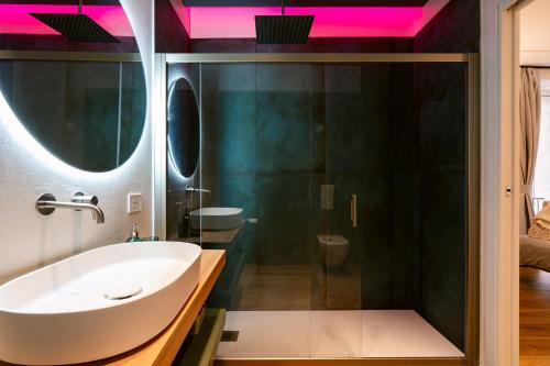 a bathroom with a white tub and a sink at NILO RELAIS a san domenico maggiore in Naples