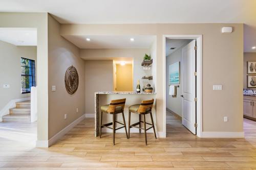 a kitchen with a bar and two stools at Hideaway #23 in Key Largo