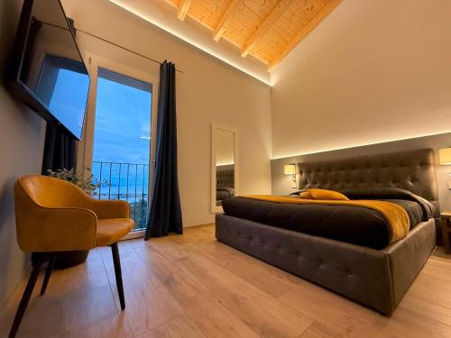 a bedroom with a bed and a chair and a window at 88 Miglia in La Spezia