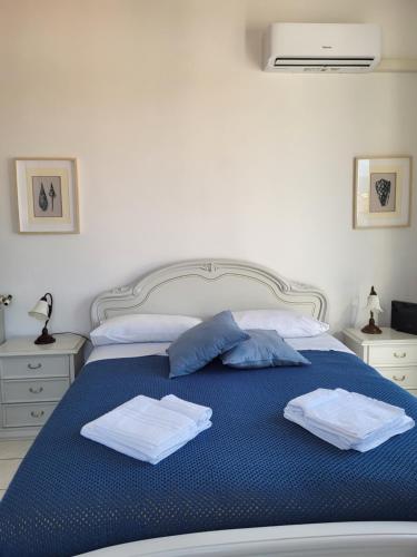 a bed with two towels on top of it at A due passi dal mare Lovely Apartment Viareggio in Viareggio