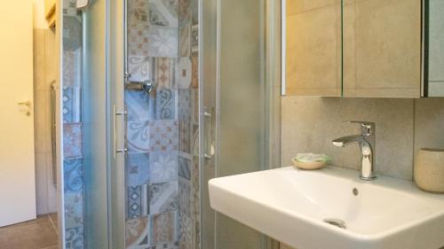 a bathroom with a sink and a shower at Bellagio, Como Lake Breva - Como Lake in Bellagio