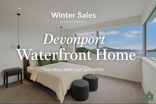 a bedroom with a bed and a window at Luxury Sun Soaked Devonport Waterfront 4BR Home in Auckland