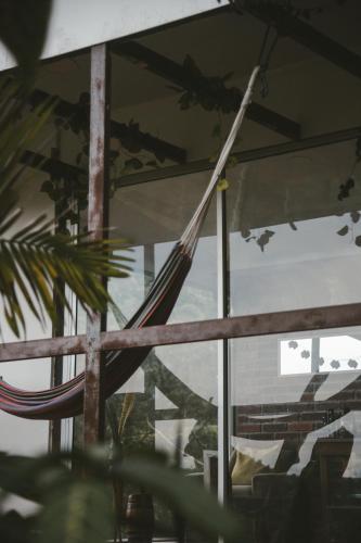 a reflection of a hammock in a window at Cabaña Tierra Verde eje Cafetero in Manizales