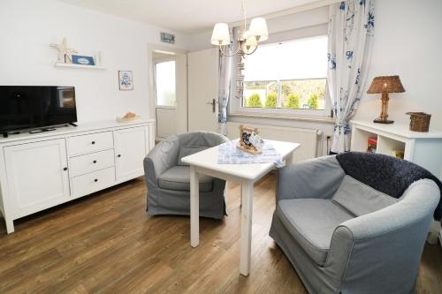 a living room with two chairs and a table at Strandkojen in Trassenheide